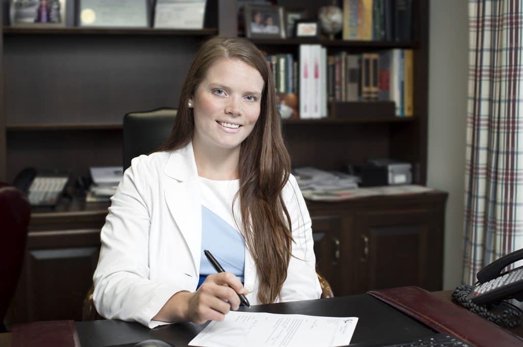 Dr. Hanner sitting at her desk smiling
